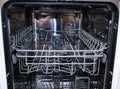 Dishwasher with open door. internal shelves of dishwasher for  distribution of dishes and  basket for cutlery Royalty Free Stock Photo