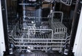 Dishwasher with open door. internal shelves of dishwasher for  distribution of dishes and  basket for cutlery Royalty Free Stock Photo