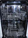 Dishwasher with open door. internal shelves of dishwasher for  distribution of dishes and  basket for cutlery Royalty Free Stock Photo