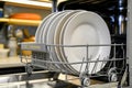 dishwasher stacking clean plates on a shelf Royalty Free Stock Photo