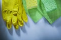 Dishwashing cloth pair of protective gloves sponges on white bac Royalty Free Stock Photo