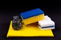 Dishwashing concept. On a black background, different washcloths and scrubbers for washing dishes