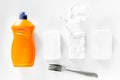 Dishwashing liquid, sponge and tableware on white background top view Royalty Free Stock Photo