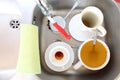 Dishwashing. White dishes in the kitchen sink. Royalty Free Stock Photo