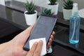 Disinfect, sanitize, hygiene care. cleaning fingerprint on mobile phone touch screen for disinfection, prevention of germs