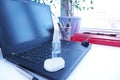 Disinfectant bottles on a black laptop in the office. Sanitizer is generally hygiene in the context of a coronavirus pandemic.