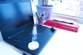 Disinfectant bottles on a black laptop in the office. Sanitizer is generally hygiene in the context of a coronavirus pandemic