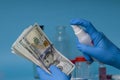 Disinfecting banknotes to stop spread of coronavirus. sterilize dollar banknotes Royalty Free Stock Photo