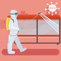 Disinfection of city streets and public transport waiting stops. Man in a special protective suit spills disinfectant on the