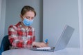 Portrait of woman cleaning laptop keyboard with wet wipe at home Royalty Free Stock Photo