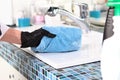 Disinfection of surfaces.Concept of cleaning services. A hand in black protective glove wipes a smooth surface with a Royalty Free Stock Photo