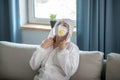 Woman in white workwear and respirator feeling tired