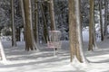 Disk golf basket in the park covered snow Royalty Free Stock Photo
