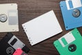 Diskettes and blank notebook on wooden background Royalty Free Stock Photo