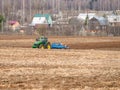 Disking soil with a tractor in Central Russia in the spring season.