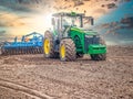 Disking soil with a tractor in Central Russia in the spring season. Royalty Free Stock Photo