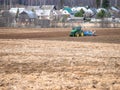 Disking soil with a tractor in Central Russia in the spring season. Royalty Free Stock Photo