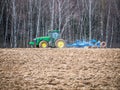 Disking soil with a tractor in Central Russia in the spring season.