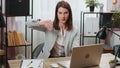 Business woman working on laptop at office showing thumbs down sign gesture dislike disapproval