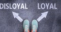 Disloyal and loyal as different choices in life - pictured as words Disloyal, loyal on a road to symbolize making decision and