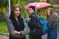 Disloyal man walking with girlfriend and looking amazed at another seductive girl Royalty Free Stock Photo