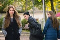 Disloyal man walking with girlfriend and looking amazed at another seductive girl Royalty Free Stock Photo