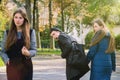 Disloyal man walking with girlfriend and looking amazed at another seductive girl Royalty Free Stock Photo