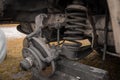 Dismantled parts of a front suspension assembly of a vintage truck. Front arms, coil spring and already removed brake caliper Royalty Free Stock Photo