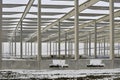 A dismantled plant hall in winter. Building site during winter. The concept of the end of the building season and the end of