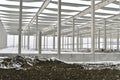 A dismantled plant hall in winter. Building site during winter. The concept of the end of the building season and the