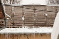 A dismantled roof with a wooden crate and hanging icicles on the edge. Royalty Free Stock Photo