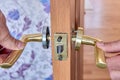 Dismantling lever door handle on inner door for repair. Royalty Free Stock Photo