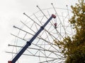 dismantling of old Ferris wheel by a car crane in an amusement park Royalty Free Stock Photo