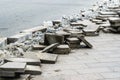 Dismantling of old, granite paving stones. Construction of a new footpath on a city street. Close-up Royalty Free Stock Photo