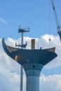 Crane lifting off sections if an old water tower in Ann Arbor, MI Royalty Free Stock Photo