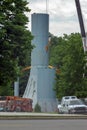 Steel cables and large crane lift a section of the old water tower