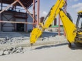 Dismantling of reinforced concrete with an excavator using a hydraulic hammer. Rigging of reinforced concrete using heavy
