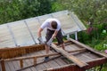 Dismantling the roof. The worker removes old boards Royalty Free Stock Photo