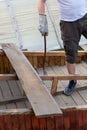 dismantling the roof. The worker removes old boards. Royalty Free Stock Photo