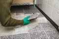 Hands take tile with chisel