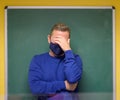 Dismayed male teacher holding his head in his hand Royalty Free Stock Photo