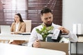 Dismissed man packing personal stuff into box in office Royalty Free Stock Photo