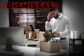 Dismissed man packing personal stuff into box in office Royalty Free Stock Photo