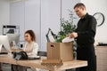 Dismissed man packing stuff into box at office Royalty Free Stock Photo