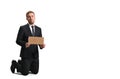 Dismissed sad manager holding a cardboard poster on a white background, business concept, unemployment and poverty