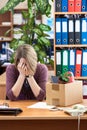 Dismissed woman crying in office