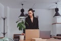 Dismissed woman packing personal stuff into box in office Royalty Free Stock Photo