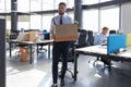 Dismissed worker going from the office with his office supplies