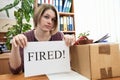 Dismissed worker with sheet of paper with fired word Royalty Free Stock Photo