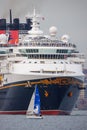 Disney Magic cruise ship on the Hudson River towering over a small sailboat Royalty Free Stock Photo